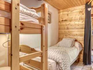Cozy and inviting, this bedroom features a charming bunk bed, perfect for accommodating guests or family.