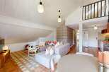 Discover this charming property featuring a stylish living area with a modern sofa and a cozy dining space.