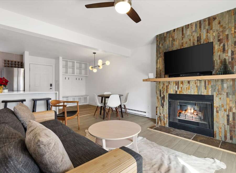 Step into this inviting living space, featuring a cozy fireplace and a modern design.