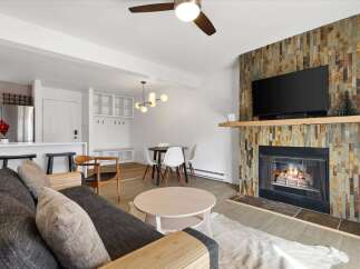 Step into this inviting living space, featuring a cozy fireplace and a modern design.