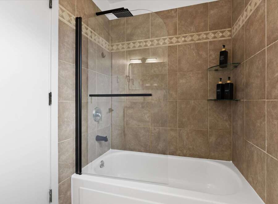 Step into a modern bathroom oasis! This stunning space features a sleek glass shower enclosure, perfect for a refreshing start to your day.