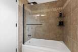 Step into a modern bathroom oasis! This stunning space features a sleek glass shower enclosure, perfect for a refreshing start to your day.