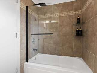 Step into a modern bathroom oasis! This stunning space features a sleek glass shower enclosure, perfect for a refreshing start to your day.