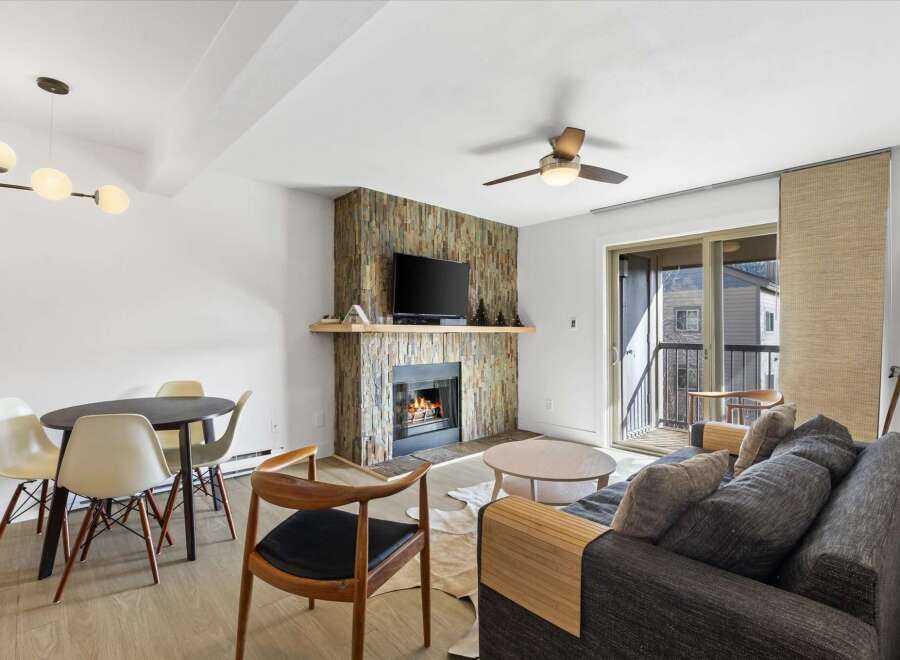 This stunning property features a cozy living room with a fireplace, perfect for relaxing evenings.