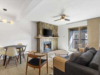 This stunning property features a cozy living room with a fireplace, perfect for relaxing evenings.