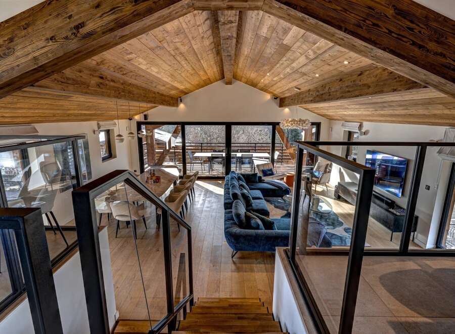 Experience luxury living in this stunning chalet, boasting a spacious open-plan design with a vaulted wooden ceiling.