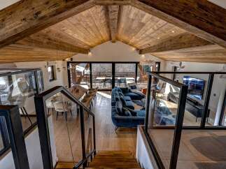 Experience luxury living in this stunning chalet, boasting a spacious open-plan design with a vaulted wooden ceiling.
