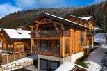 Discover the charm of this stunning wooden chalet nestled in a picturesque winter landscape.