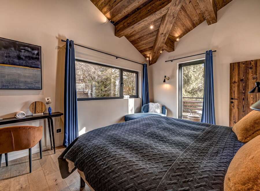 Experience luxury in this stunning bedroom featuring a cozy bed with plush pillows and a stylish design.