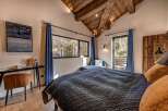 Experience luxury in this stunning bedroom featuring a cozy bed with plush pillows and a stylish design.