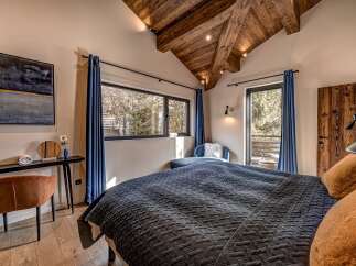 Experience luxury in this stunning bedroom featuring a cozy bed with plush pillows and a stylish design.
