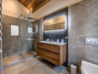 Step into luxury with this stunning bathroom featuring a modern design and high-end finishes.