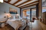 Experience luxury and comfort in this stunning bedroom featuring two twin beds, perfect for a relaxing getaway.