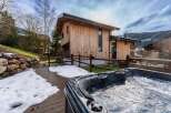 Experience luxury living in this stunning wooden chalet, complete with a private hot tub.