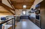 Experience luxury living in this stunning property, featuring a modern kitchen with sleek cabinetry and high-end appliances.
