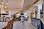 Experience luxury living in this stunning property featuring a unique architectural design with exposed wooden beams and vaulted ceilings.