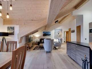 Experience luxury living in this stunning property featuring a unique architectural design with exposed wooden beams and vaulted ceilings.