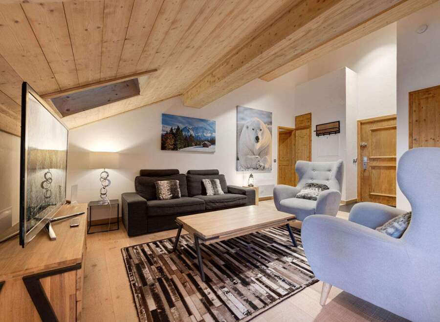 This stunning living room boasts a cozy atmosphere with its wooden ceiling and inviting decor.