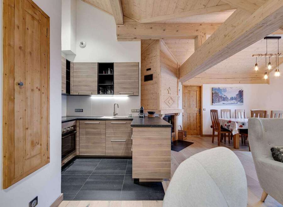 This stunning property boasts a modern kitchen with sleek cabinetry and a dark countertop, perfect for culinary enthusiasts.