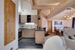 This stunning property boasts a modern kitchen with sleek cabinetry and a dark countertop, perfect for culinary enthusiasts.