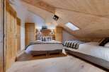 Experience the charm of this cozy bedroom featuring a unique wooden ceiling and flooring.