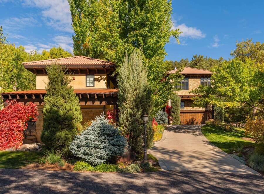 This stunning property boasts a beautiful exterior with lush landscaping and a welcoming driveway.