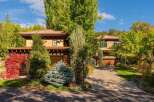 This stunning property boasts a beautiful exterior with lush landscaping and a welcoming driveway.