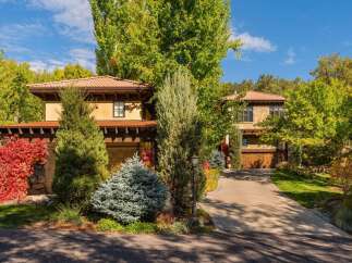 This stunning property boasts a beautiful exterior with lush landscaping and a welcoming driveway.