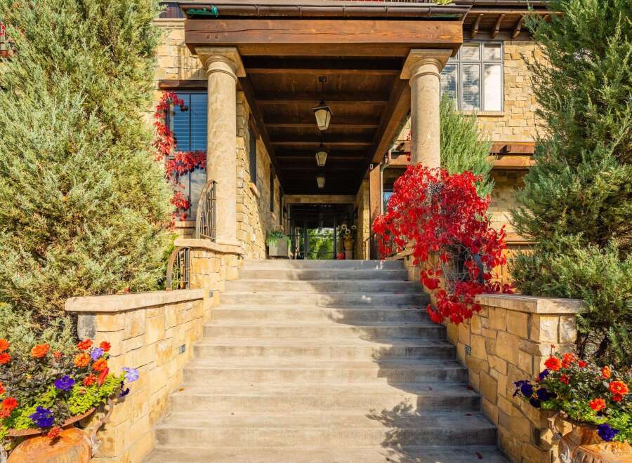 Step into luxury with this stunning property, showcasing an inviting entrance with a grand staircase.