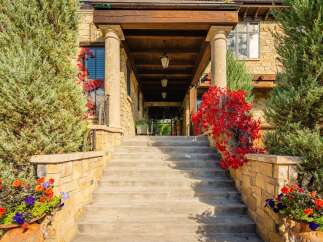 Step into luxury with this stunning property, showcasing an inviting entrance with a grand staircase.