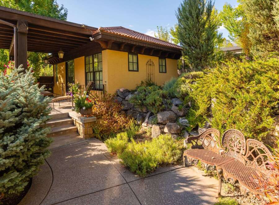 Discover the charm of this stunning property, featuring a beautifully designed exterior with a covered patio and lush landscaping.