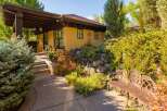 Discover the charm of this stunning property, featuring a beautifully designed exterior with a covered patio and lush landscaping.