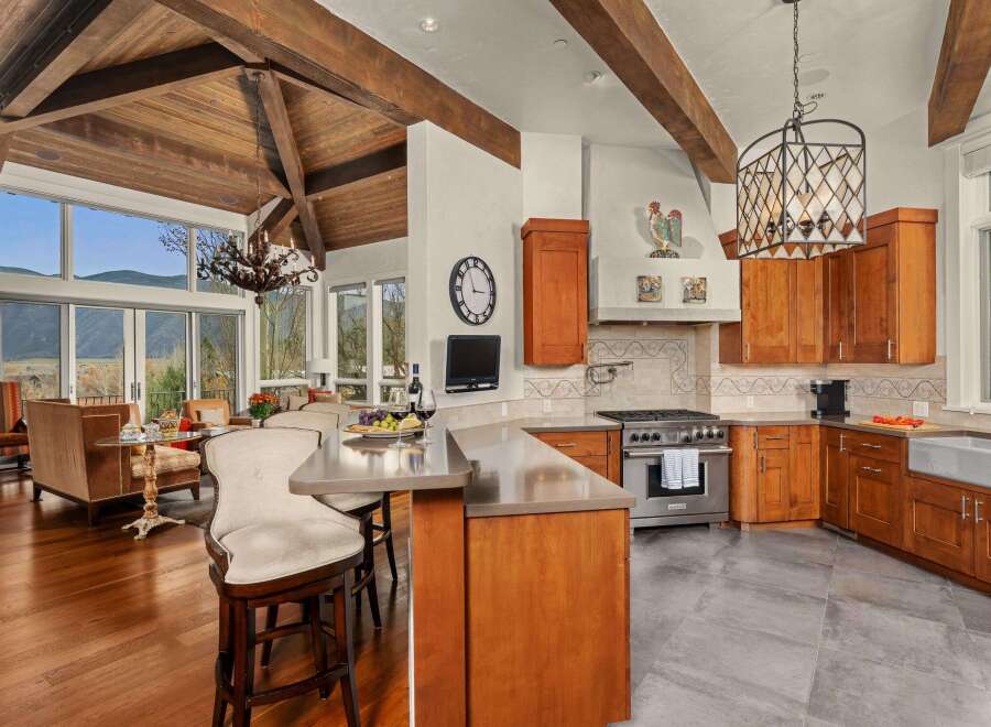 Experience luxury living in this stunning kitchen! Featuring a gourmet Wolf range, custom cabinetry, and a spacious island, this kitchen is perfect for both cooking and entertaining.