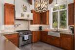 This stunning kitchen boasts custom cabinetry, a high-end Wolf range, and a farmhouse sink, perfect for culinary enthusiasts.