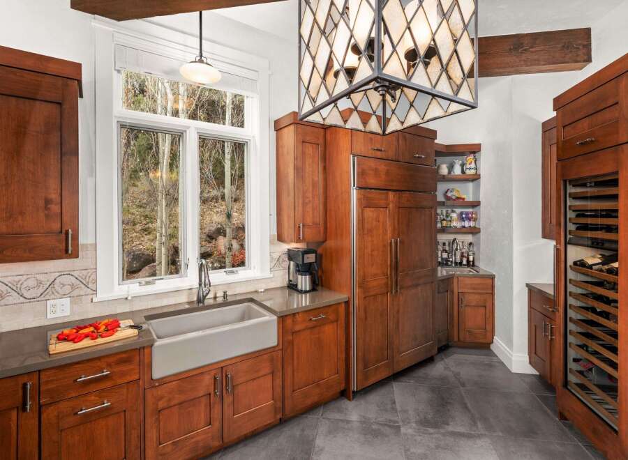 This stunning kitchen boasts custom cabinetry, a farmhouse sink, and a built-in refrigerator, creating a seamless and stylish space.