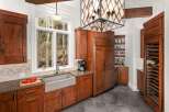 This stunning kitchen boasts custom cabinetry, a farmhouse sink, and a built-in refrigerator, creating a seamless and stylish space.