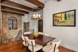 Step into luxury with this stunning dining area, featuring a rich, dark wood dining table and elegant upholstered chairs.