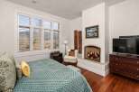 This luxurious bedroom features a cozy fireplace, perfect for relaxing on chilly evenings.