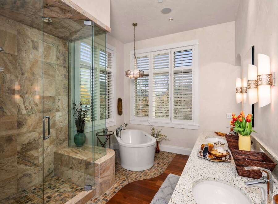 Step into luxury with this stunning bathroom! Featuring a spacious walk-in shower with beautiful tile work and a modern glass enclosure, this bathroom is a true oasis.