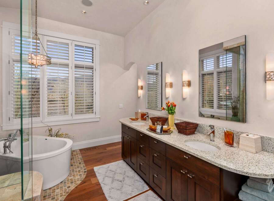 Step into luxury with this stunning bathroom featuring a spacious vanity with dual sinks and a beautiful countertop.