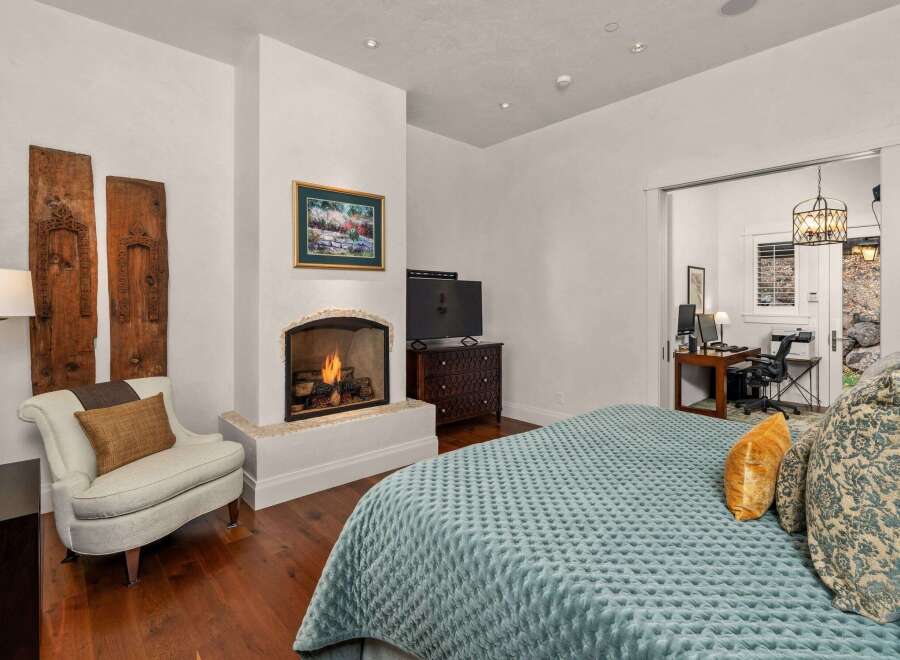 This luxurious bedroom boasts a cozy fireplace, perfect for relaxing evenings.