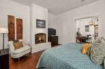 This luxurious bedroom boasts a cozy fireplace, perfect for relaxing evenings.