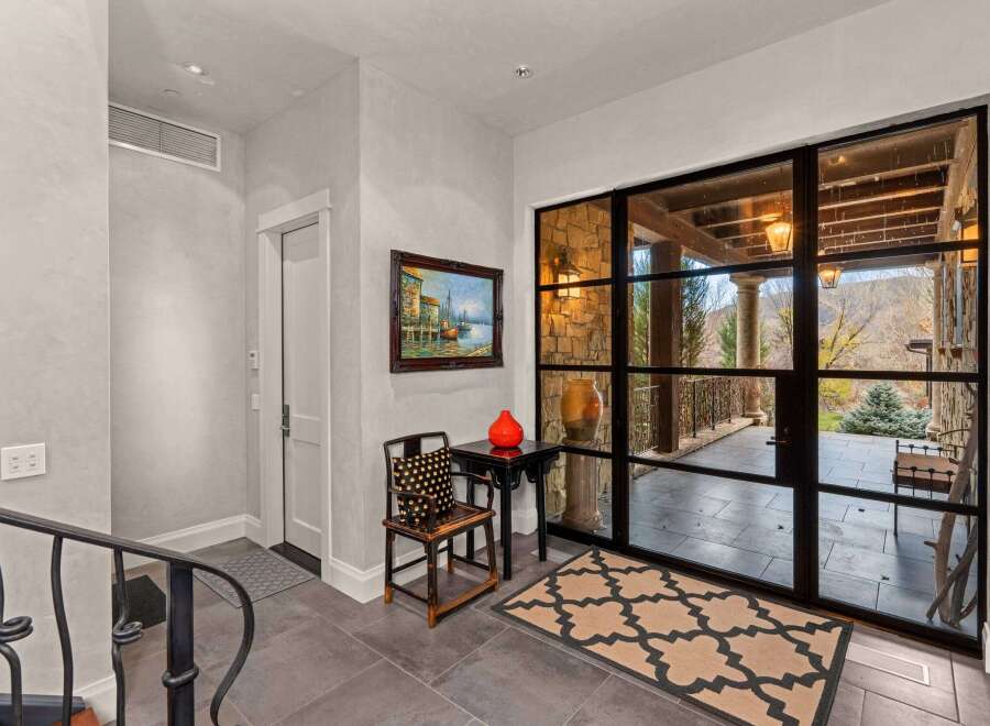 Step into luxury with this stunning entryway, showcasing a blend of modern and classic design.