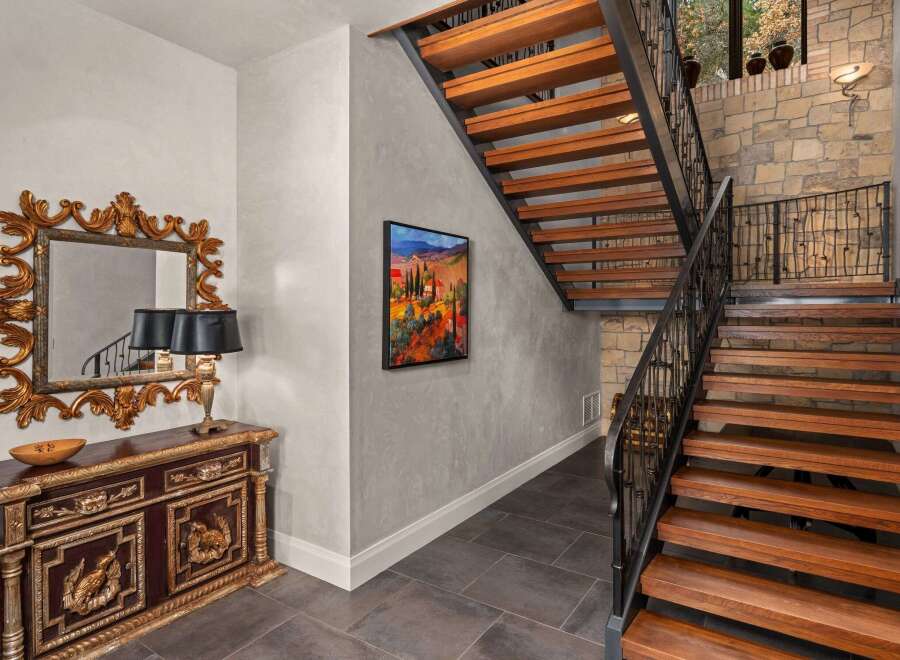 Step into luxury with this stunning property featuring a grand staircase and elegant entryway.