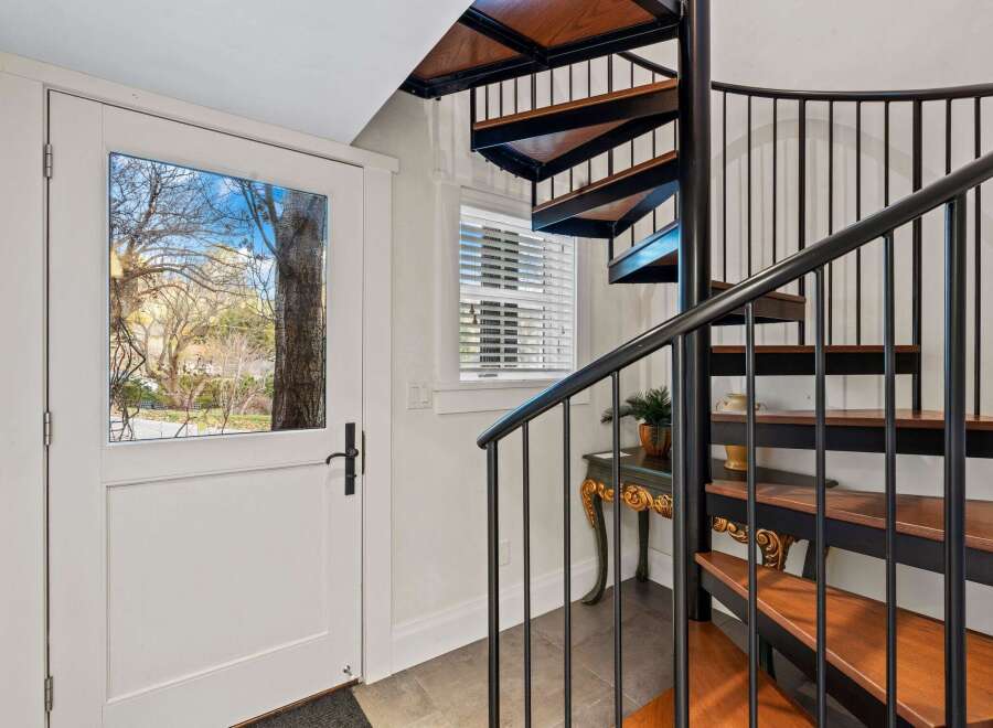 This stunning property features a beautiful spiral staircase, adding a touch of elegance and sophistication.