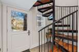 This stunning property features a beautiful spiral staircase, adding a touch of elegance and sophistication.