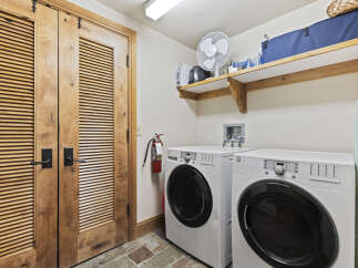 This laundry room features a modern design with a front-load washer and dryer.