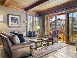 This stunning living room boasts a warm and inviting atmosphere, perfect for relaxation and entertaining.