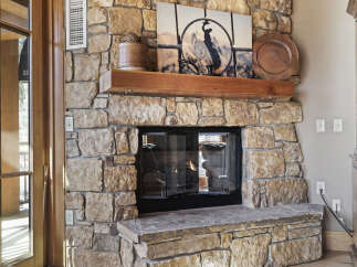 This stunning property boasts a beautiful stone fireplace, perfect for cozy evenings.