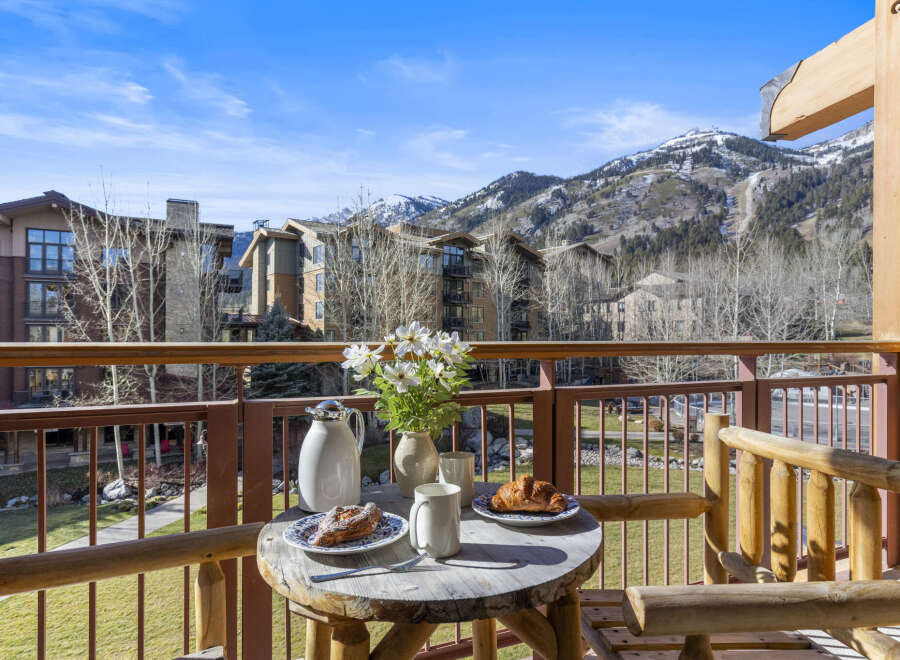 Enjoy breathtaking mountain views from this charming balcony.